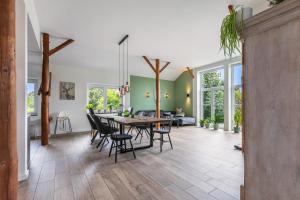 a large living room with a table and chairs at Hof Wuushöh in Stolk