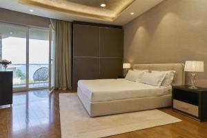 a bedroom with a bed and a large window at Adriatic Istria Resort by Minor Hotels in Savudrija