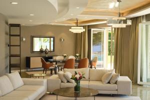 a living room with couches and a dining room at Adriatic Istria Resort by Minor Hotels in Savudrija