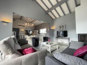 a living room with a couch and a table at Uhalden borda in Saint-Jean-de-Luz