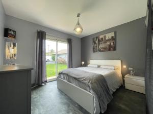 a bedroom with a bed and a large window at Uhalden borda in Saint-Jean-de-Luz +32 photos