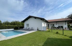 a house with a swimming pool in a yard at Uhalden borda in Saint-Jean-de-Luz