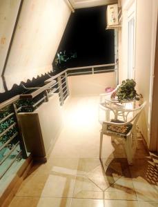 a room with a table and a chair on a balcony at CS apartment Patra in Patra