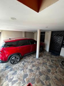 a red car is parked in a garage at Palmeras house in Ica