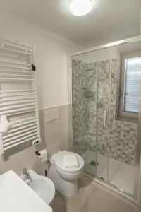 a bathroom with a toilet and a glass shower at Al Cantuccio Affittacamere in Assisi
