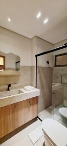 a bathroom with a toilet and a sink and a shower at Chale Praia Barrinha in Barrinha +18 photos