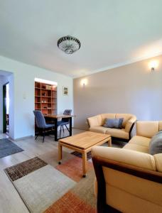 a living room with a couch and a table at Apartmán 24 in Medzilaborce