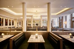 a restaurant with two tables and a bar at The Bedford Hotel Belfast in Belfast