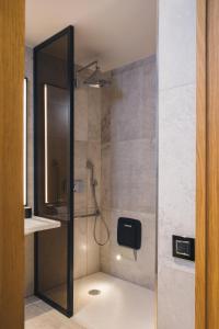 a shower with a glass door in a bathroom at Grand Hyatt Barcelona in Barcelona