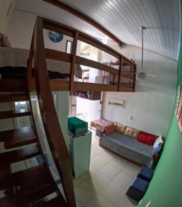 a small room with a bunk bed and a staircase at Chale Maresias 1 in São Sebastião +12 photos