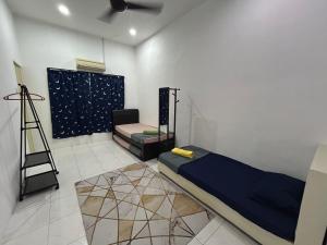 a room with a bed and a ladder in it at Fairuz Homestay Ipoh in Ipoh