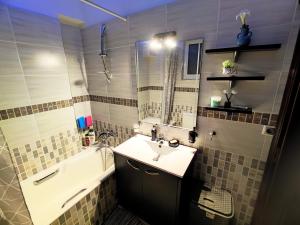 a bathroom with a sink and a bath tub and a sink at CS apartment Patra in Patra
