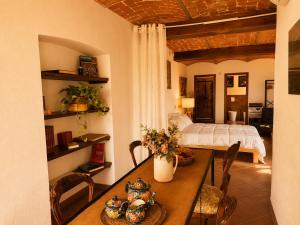 a bedroom with a table and a bed in a room at Country Loft Colle Miroteo in Monforte dʼAlba