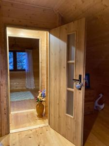 a small room with a door in a wooden house at Nela Martiany in Martiany