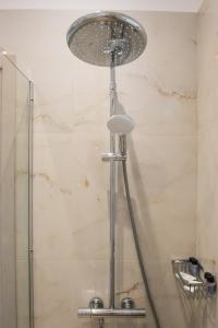 a shower with a shower head in a bathroom at Aimilia Boutique Studio Kalathos in Kalathos