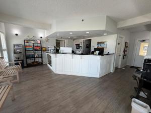 a large room with a counter and a room with chairs at The Islander Inn in Ocean Isle Beach