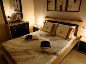 a bedroom with a large bed and a mirror at CS apartment Patra in Patra