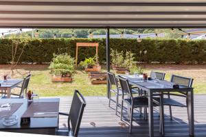 a table and chairs sitting on a wooden deck at ibis budget Lyon Est Chaponnay in Chaponnay