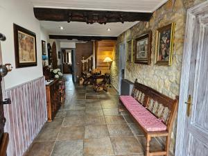 a hallway with a bench in a stone wall at Posada Herrán in Santillana del Mar +23 photos