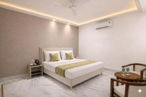 a bedroom with a large white bed in a room at Hotel ravan in New Delhi