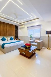 a bedroom with a bed and a couch and a table at Hotel ravan in New Delhi
