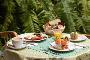 a table with plates of breakfast food and a cup of coffee at Hotiday Tenerife Norte in Puerto de la Cruz