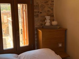 a bedroom with a bed and a window at Luxe Lane Kalamoti in Chios