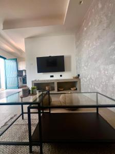 a living room with a flat screen tv on a wall at Iconic Project Lagada in Amorgos +2 photos