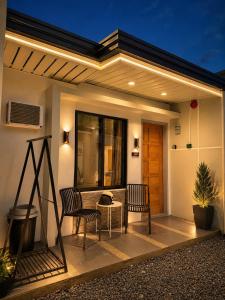 a patio with two chairs and a table at K&M Studio Suites Casa KM in Bingag