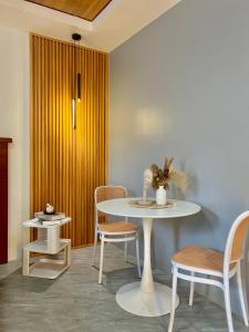 a table and chairs in a room with a yellow door at K&M Studio Suites Casa KM in Bingag