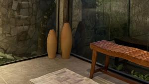 three vases sitting on the floor next to a table at Exclusive Huts in Gravatá