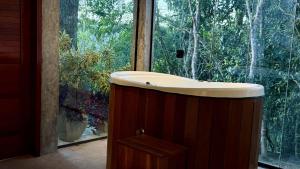 a bathroom with a sink in front of a window at Exclusive Huts in Gravatá