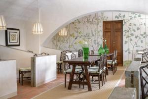 a dining room with a table with chairs and flowers at Torre a Cona Wine Estate in Florence