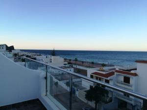a view of the ocean from the balcony of a building at Huge oceanfront apartment in Tétouan