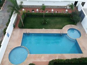 an overhead view of a swimming pool in a resort at Huge oceanfront apartment in Tétouan