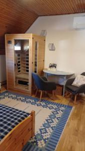 a living room with a table and chairs and a table at Revans teázó apartman- belváros in Pápa