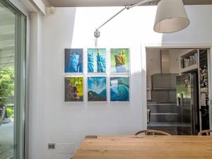 a dining room with a table and some pictures on the wall at Villa Mulberry Garden by Interhome in San Marcello