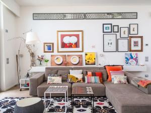 a living room with a brown couch and pictures on the wall at Villa Mulberry Garden by Interhome in San Marcello +163 photos