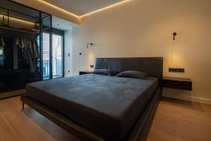 a bedroom with a large bed in a room at Luxury Sea View 2BR Apt - Balcony & Free Parking in Volos