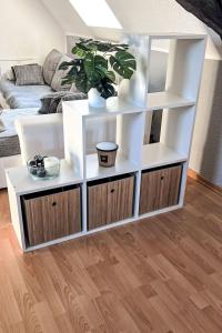 a living room with white shelves and a couch at Apartment Workbase Nidderau by Interhome in Nidderau +4 photos