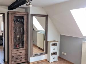 a room with a mirror and a dresser at Apartment Workbase Nidderau by Interhome in Nidderau