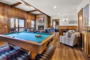 a pool table in a living room with wooden walls at Shawnee Ridge Lodge in Banner Elk
