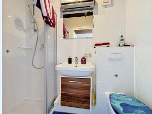 a bathroom with a sink and a shower and a toilet at Studio Sirch-1 by Interhome in Diedorf