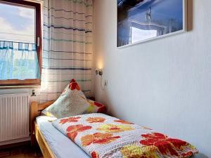 a small bedroom with a bed and a window at Studio Sirch-1 by Interhome in Diedorf +7 photos