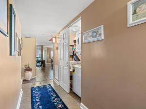 a hallway with a door leading to a kitchen at Oceanfront Get Away in Myrtle Beach