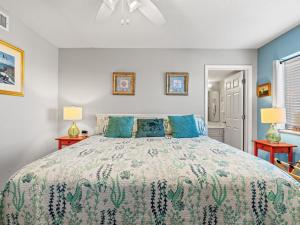a bedroom with a large bed with blue walls at Oceanfront Get Away in Myrtle Beach