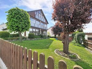 a wooden fence in front of a house at Studio Sirch-1 by Interhome in Diedorf