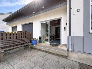 a wooden bench sitting outside of a house at Studio Sirch-1 by Interhome in Diedorf