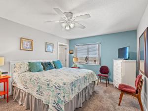 a bedroom with a bed and a ceiling fan at Oceanfront Get Away in Myrtle Beach