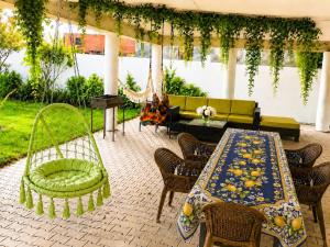 a patio with a table and chairs and a couch at Sea & Sun Grigoleti in Grigoleti